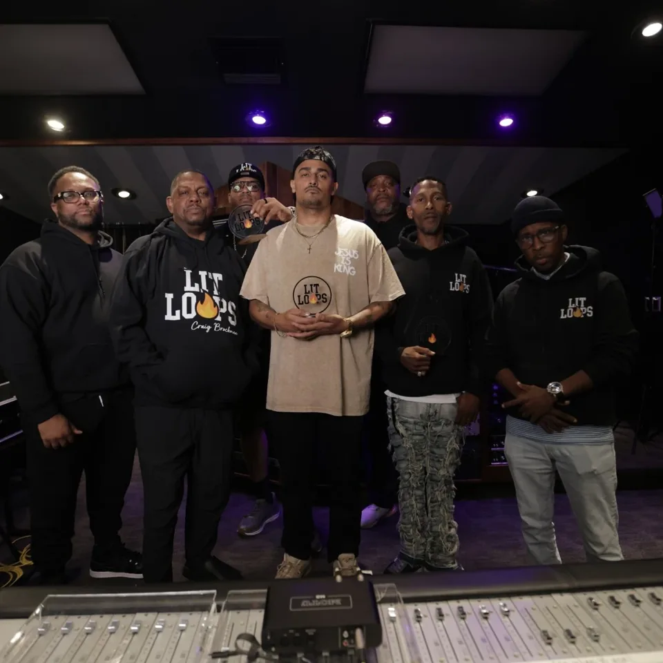 The team gathered in a recording studio