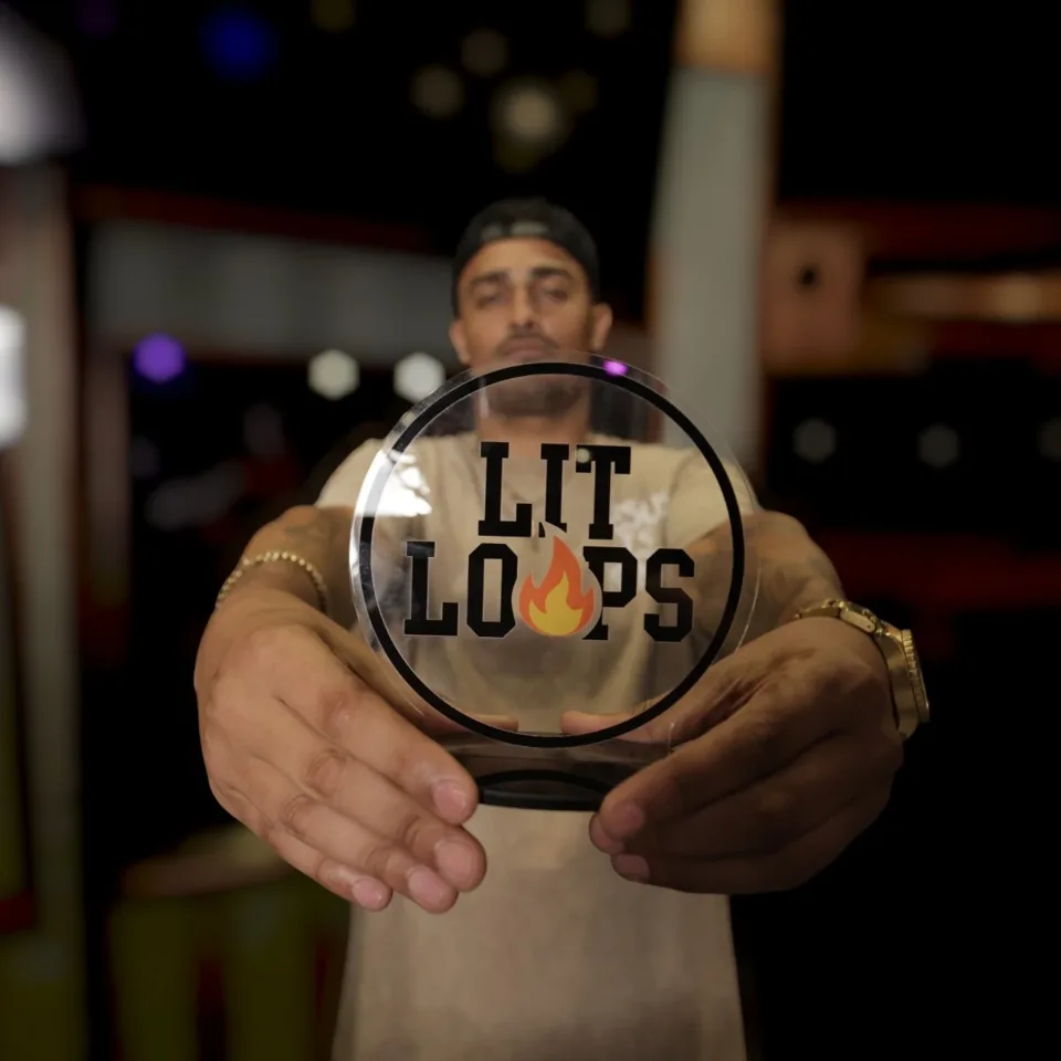 A team member holding the Lit Loops sign